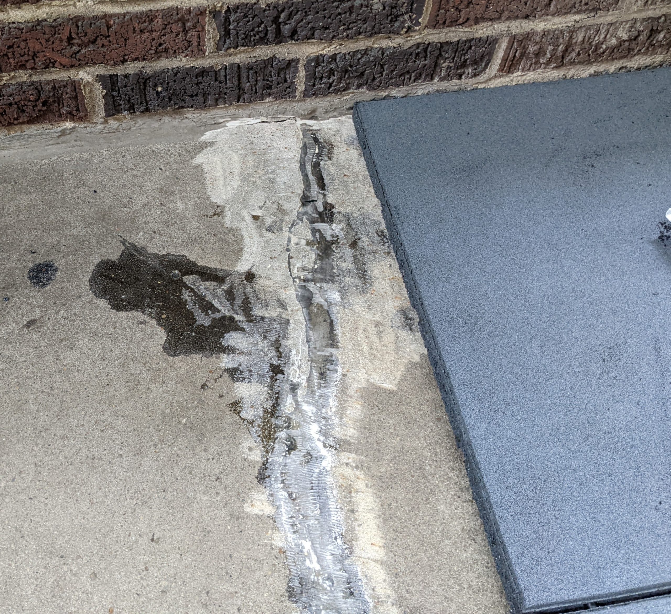 A repaired crack in a concrete floor.